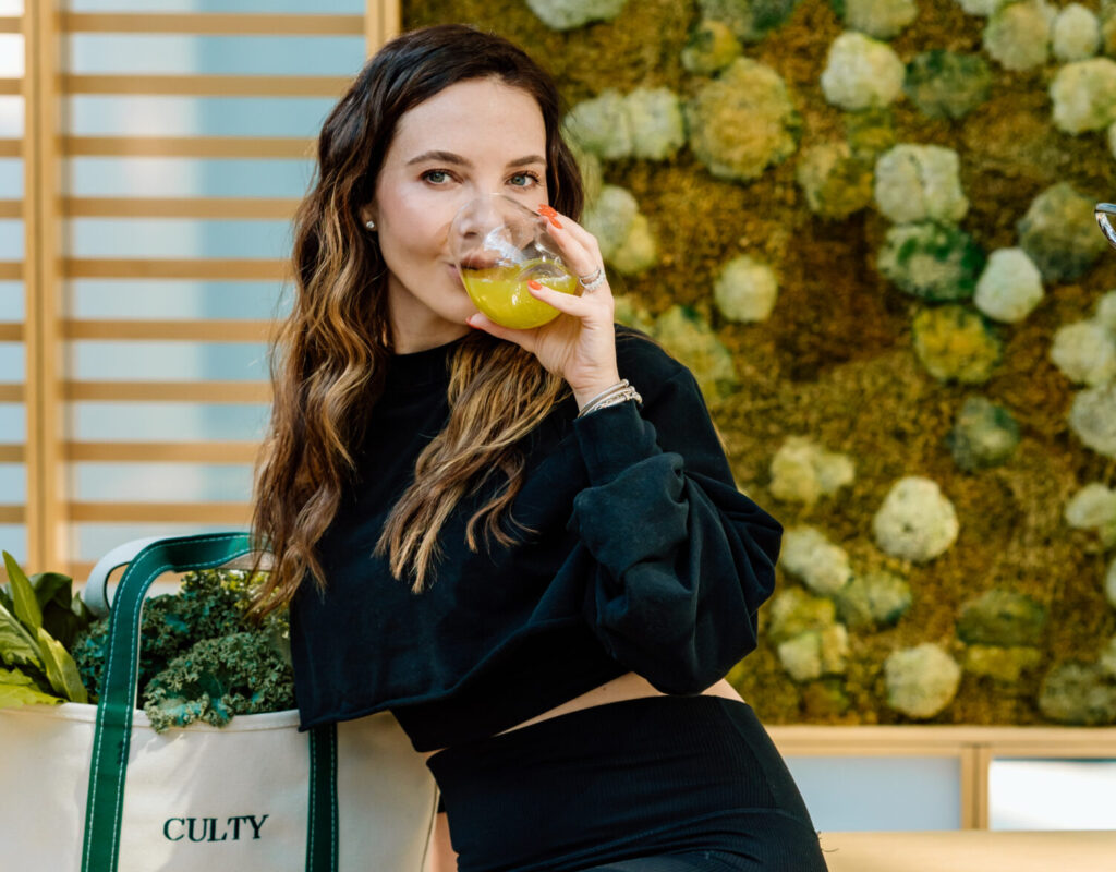 Allie holding a glass sitting down