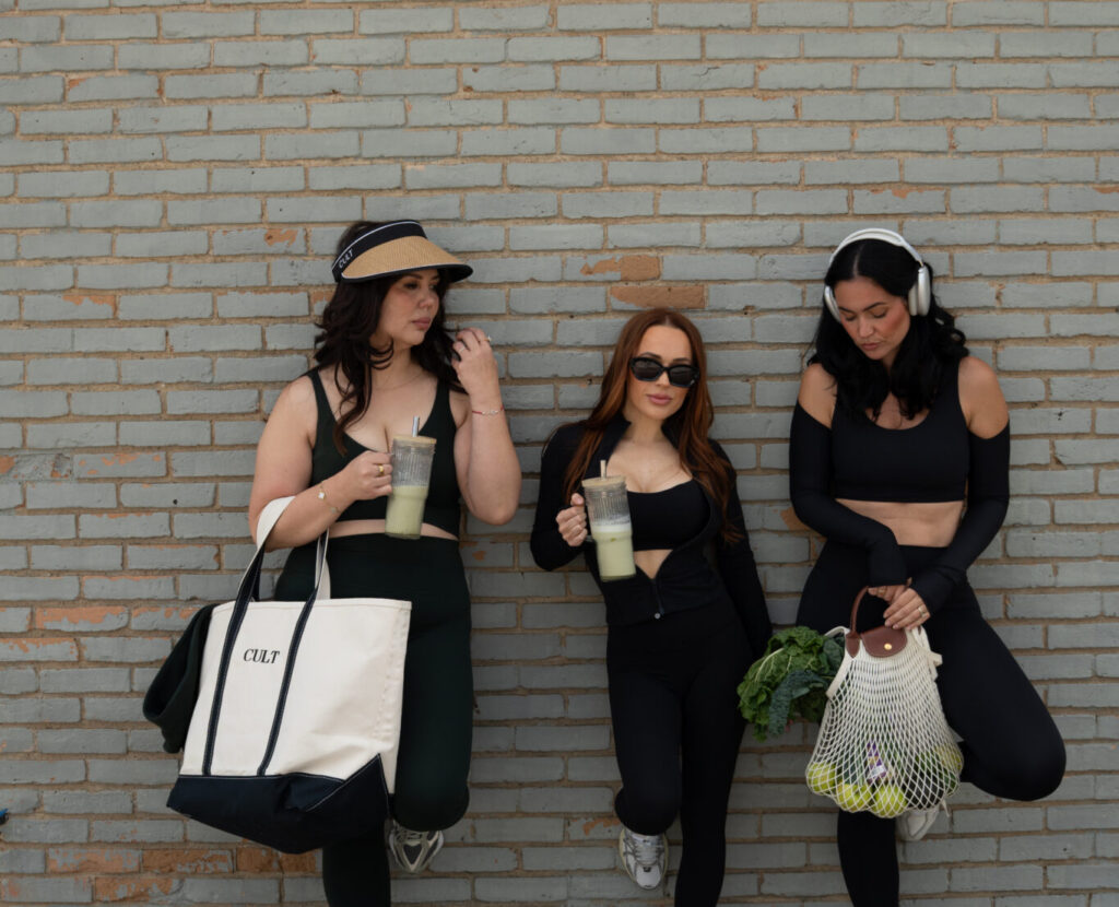 Three woman standing with their backs to the wall