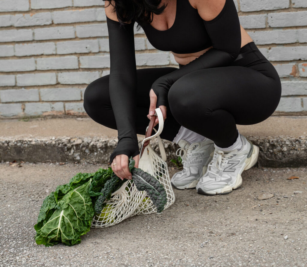 Woman picking up lettuce off the ground