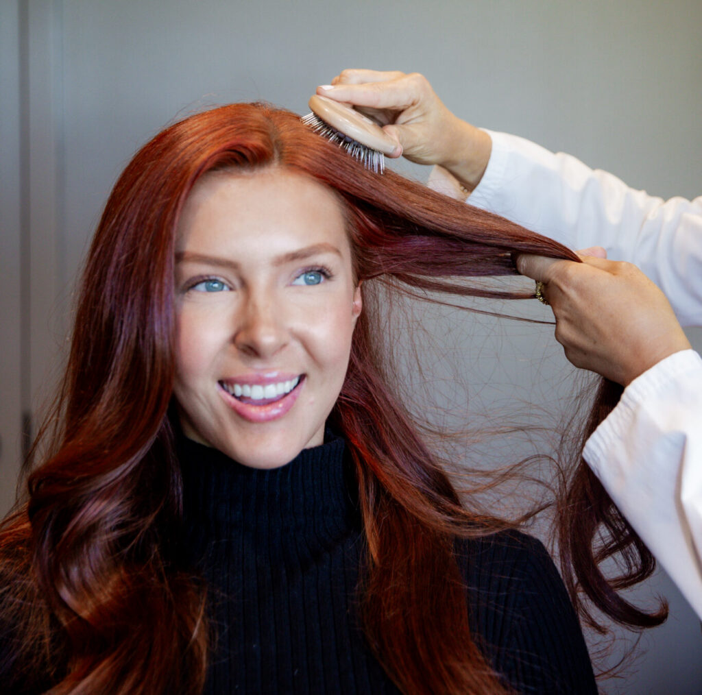 women getting her hair brushed